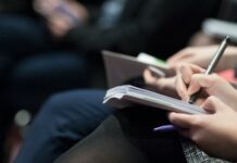 고용보험 재원, 재직자 교육에 집중 투자해야 selective focus photography of people sitting on chairs while writing on notebooks