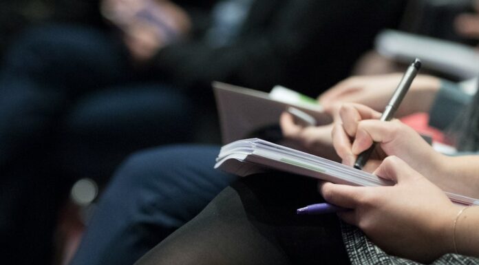 고용보험 재원, 재직자 교육에 집중 투자해야 selective focus photography of people sitting on chairs while writing on notebooks
